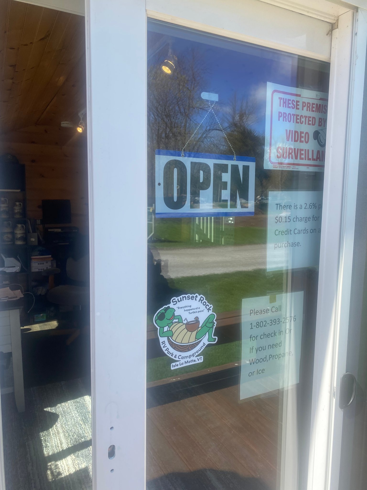 Sunset Rock office open sign with campground logo